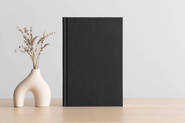 istock Black book mockup with a lavender decoration on the wooden table. 1489391214