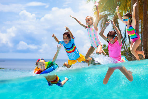 istock Kids jump into swimming pool. Summer water fun. 1489392945