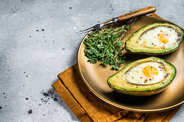 istock Brunch with Baked Avocado and Egg. Gray background. Top view. Copy space 1489394026