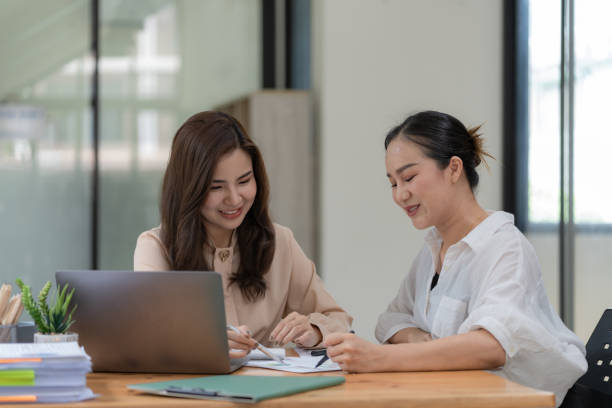 istock Two Young Asian businesswomen discuss with new startup project Idea presentation and analyze planning and financial statistics and investment market at an office. 1489394813