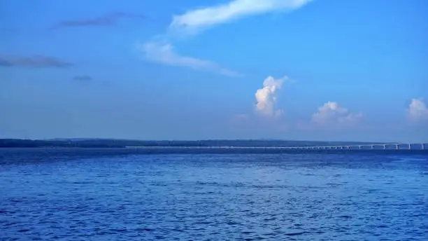 Photo of View of the end of the bridge crossing the strait between the islands of Java and Madura. view of island, sea and clear blue sky