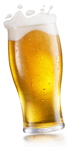 Chilled glass of beer and splashed foam drops. File contains clipping path. Chilled glass of beer and splashed foam drops. File contains clipping path. beer glass splash stock pictures, royalty-free photos & images