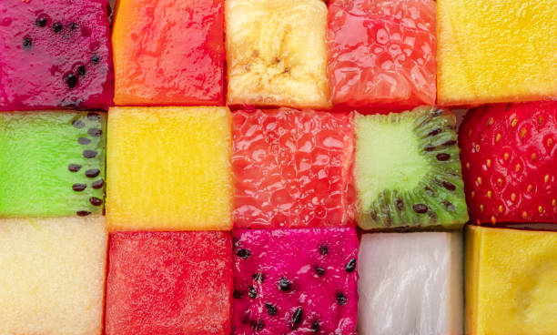 istock Fruit puzzle. Colorful food background or pattern arranged of different fruit cubes. Dietary concept. 1489397566