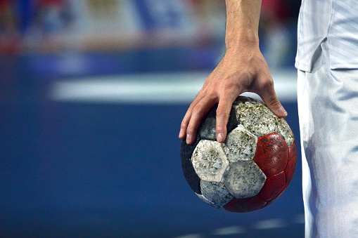 Handball Player warming up while holding a handball