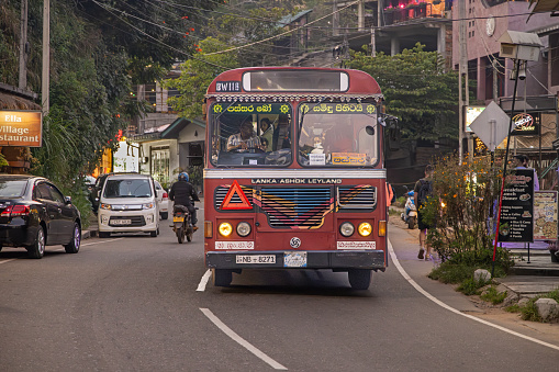 Ella, Uva Province, Sri Lanka - February 16th 2023:  Bus in the main street in the center of Ella in the late afternoon. The bus system cover all of Sri Lanka and is the main public transportation system