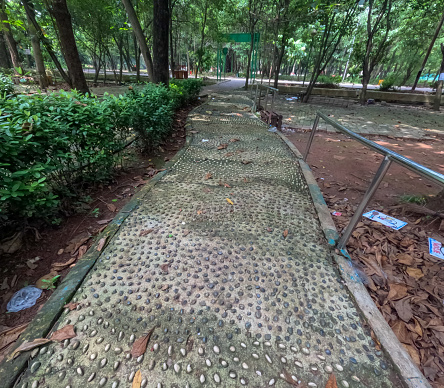 Stone reflexology path for abandoned foot massage. Round convex white pebbles for massage systems to relieve tension and treat ailments.