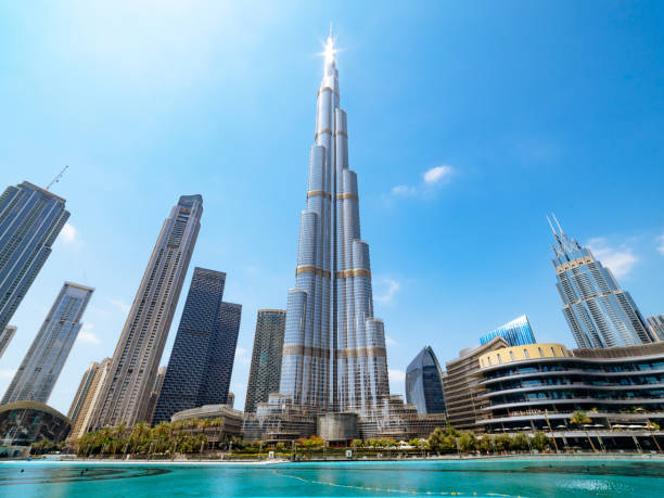 Dubai, United Arab Emirates - March 29, 2023: Downtown cityscape of Dubai, UAE. View of Burj Khalifa on day with sun reflecting from it on the top