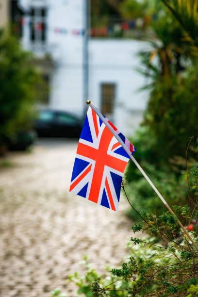 istock British flag on cobblestone residential street 1489411956