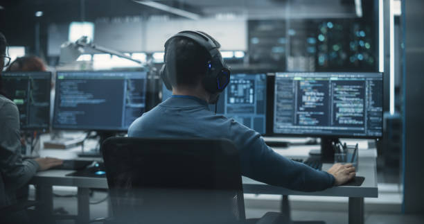 istock Group of Empowered Multicultural Men and Women Working in a Research Center, Using Computers to Run Advanced Software and Develop Artificial Intelligence Interface 1489412793