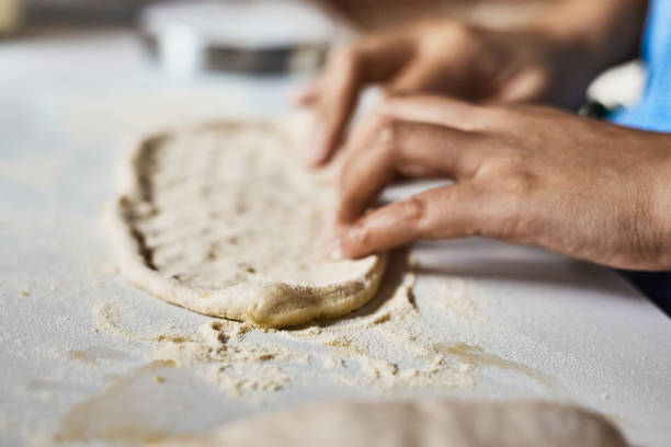 istock Hands knead dough to make a pizza 1489413981