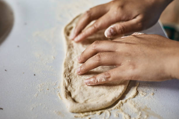 istock Hands knead dough to make a pizza 1489414118