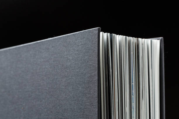 Corners of a black textile book cover close up.