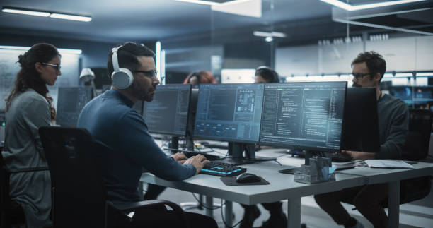 istock Team of Talented Young Professionals Working in a Technological Research and Development Agency. Young Female Developer Working with AI Software and Mapping Technical Neural Network Data Set 1489414780