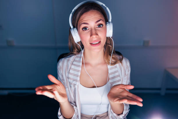 istock Woman having online meeting while working overtime in an office 1489415422