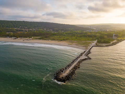 Aerial top view of the sea, beach, and forest from above. It's a beautiful natural landscape that's perfect for nature lovers and anyone seeking a scenic and picturesque escape.