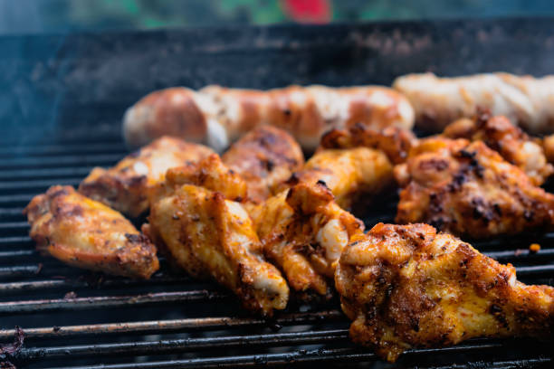 istock Marinated meat, chicken, ribs and sausages put on the barbecue 1489417463