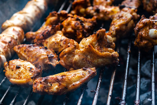 istock Marinated meat, chicken, ribs and sausages put on the barbecue 1489417512