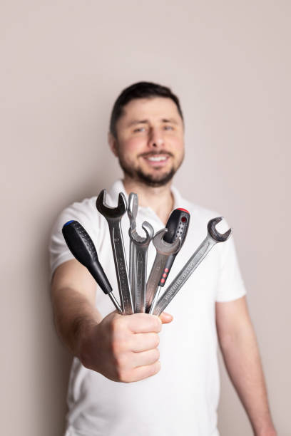 Man with bouquet of wrenches and screwdrivers