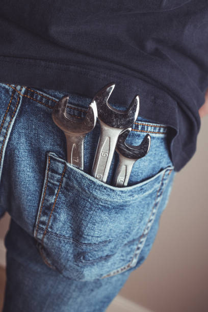 Man with wrenches in back pocket of his jeans. Ideal for industrial, mechanical, and DIY projects