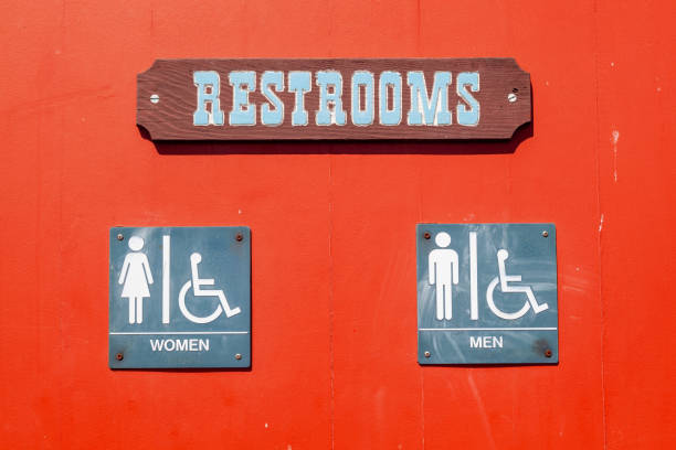 istock sign restroom at a red wall with shadow 1489421406