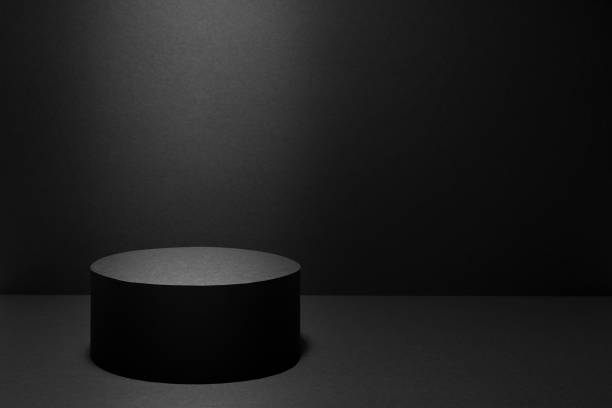 istock Abstract black stage with one round podium in light ray with light spot mockup for presentation cosmetic products, goods, advertising, design in soft gradient, in elegant rich style, copy space. 1489423936