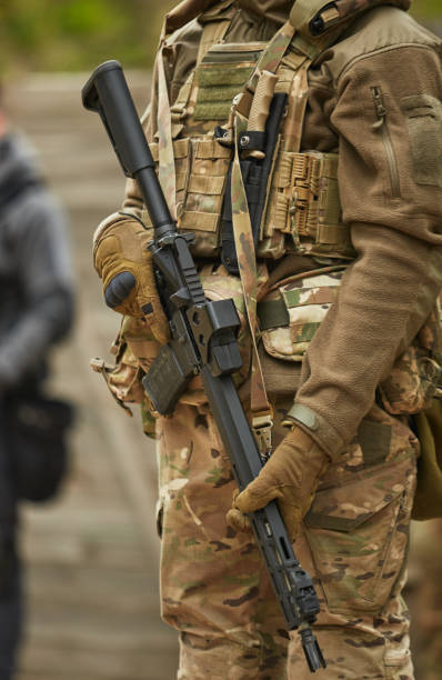 istock Ukrainian soldier armed with modern American assault rifle equipped with magnifier scope training on the shooting range. Armed forces of Ukraine recruit practicing outdoor 1489424910