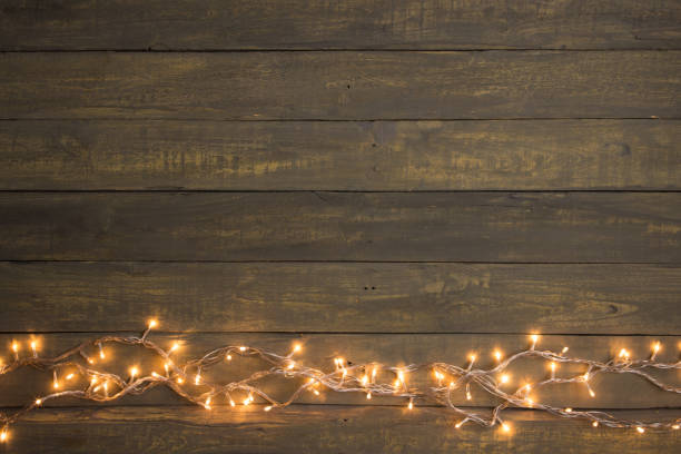 istock Christmas lights on a wooden background. Copy space for a greetings 1489427276