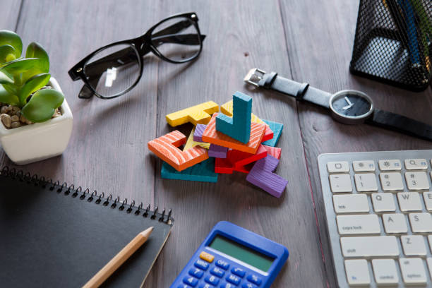 istock Business creative idea and teamwork concept - jigsaw puzzle, notebook on the wooden desk 1489427923