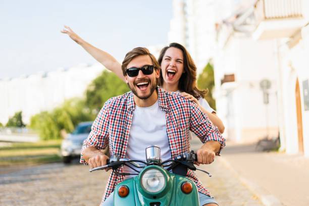 istock Vacationing couple riding motor scooter 1489429088