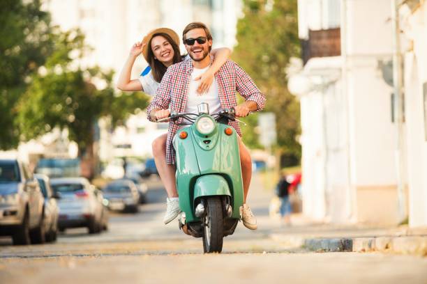 istock Vacationing couple riding motor scooter 1489429325