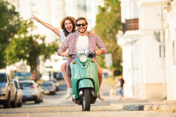 istock Vacationing couple riding motor scooter 1489429383