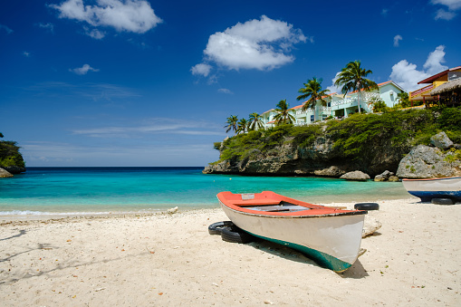 Two wooden fishing boats on the crystal clear turquoise waters at Lagoon on Curacao.