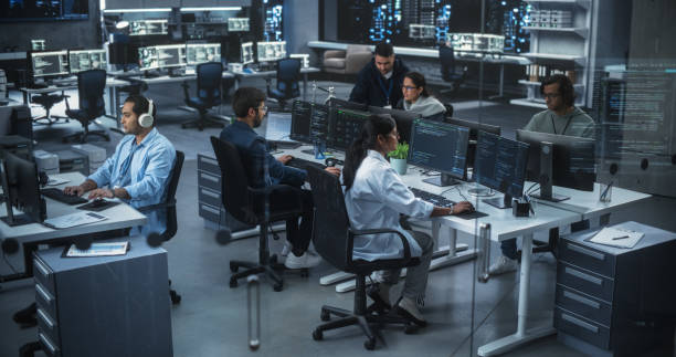 istock Diverse Young Indian Colleagues Working on Computers in a Research Laboratory. Focus on Female Software Developer Colleague Working on a Solution for Their Collaborative Industrial Tech Project 1489431013