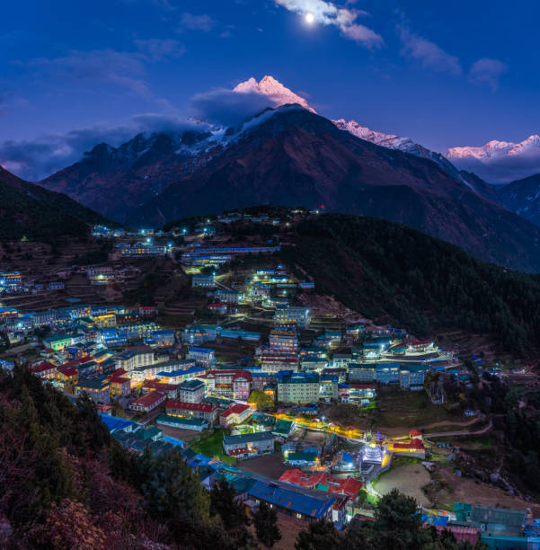 Moonrise over Namche Bazaar alpenglow on Thamserku Himalayan mountains Nepal