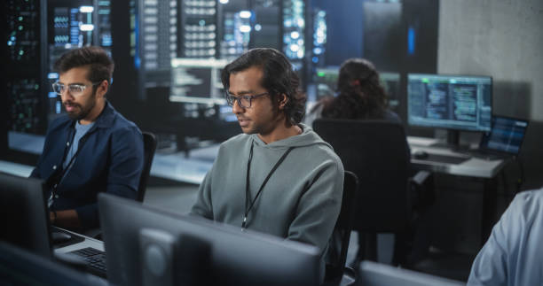istock Portrait of a Handsome Indian Engineer Working on Desktop Computer in a Technological Office Environment. Research and Development Department Writing Software Code for an Innovative Internet Project 1489431600