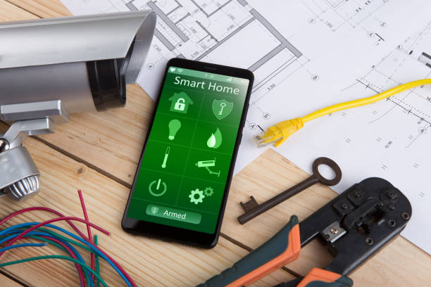 istock Home security concept smartphone with smart home app and surveillance cctv camera on the desk 1489431620