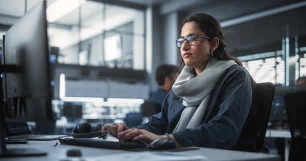 istock Portrait of a Thoughtful South Asian Engineer Working on Computer in a Technological Corporate Office. Young Woman Writing Software Code for an Innovative Internet and Software as a Service Project 1489431859