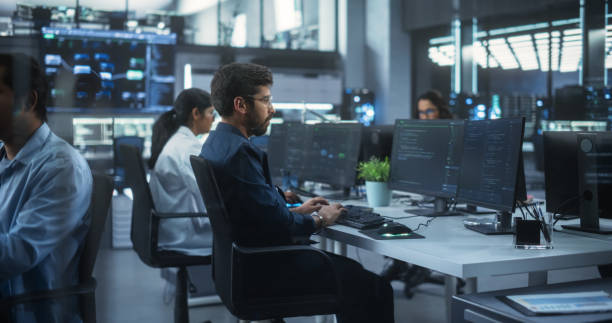 istock Team of Talented Young Indian Professionals Working in a Technological Research and Development Agency in South Asia. Computer Screens with Software Code and Artificial Intelligence Projects 1489432147