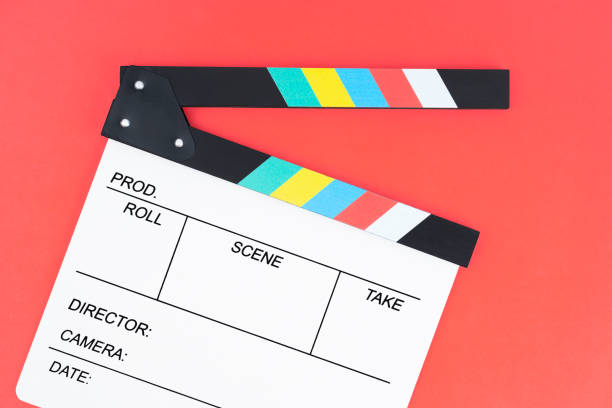 istock The Filmmaker profession. Clapperboard on red background. 1489432265
