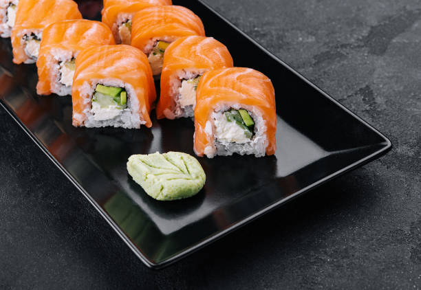 istock Delicious philadelphia sushi on black stone plate 1489432365