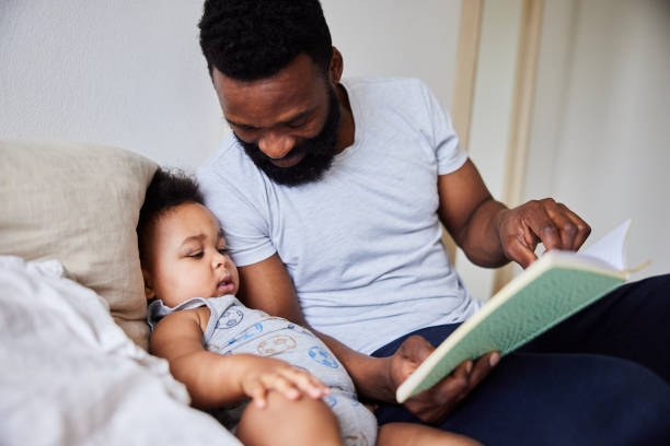 istock Loving dad reading a his little a boy book in bed 1489434096