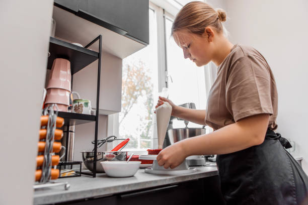 istock Beautiful female home baker preparing a cake for delivery 1489437651