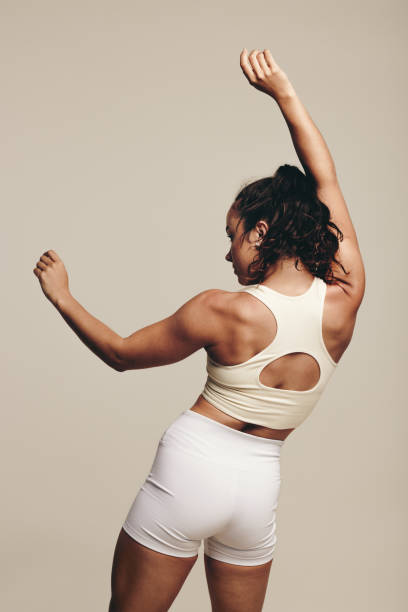 istock Woman improving her lean physique with toning body movements in a studio 1489441461