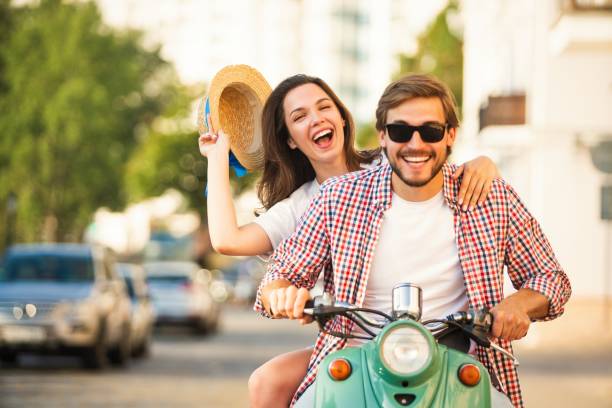 istock Vacationing couple riding motor scooter 1489443623