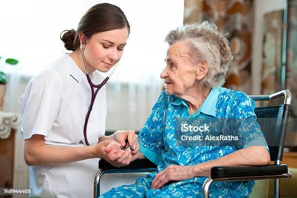 Inhome Nurse Helping An Elderly Woman Stock Photo - Download Image Now - Community Outreach, Physical Pressure, Nurse