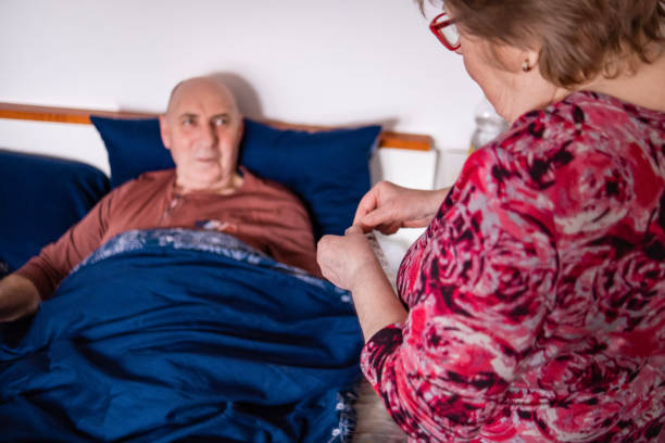istock Giving my ill husband medicine before bed 1489444942