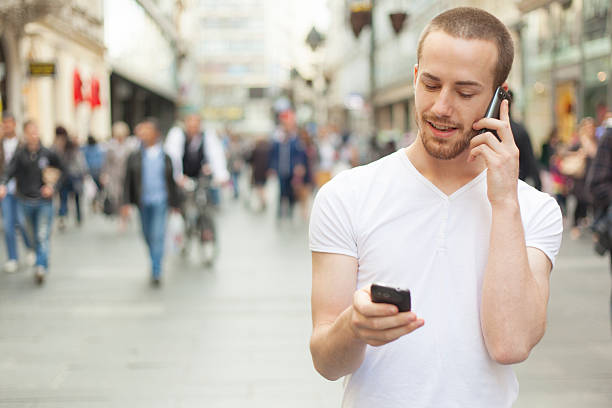 istock Speaking on mobile phone and holding secund cell in hand 148944889