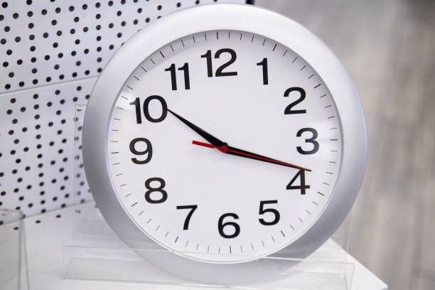 istock A simple white round wall clock stands and is sold on a shelf in a store 1489454953