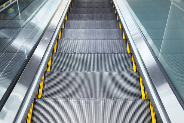istock Top view on steps of escalator modern buildings or subway station 1489455090
