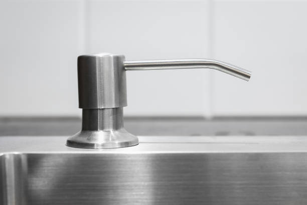 istock Liquid soap dispenser built into modern metal sink 1489455095